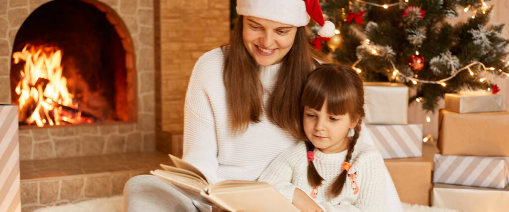 mother and daughter reading on Christmas