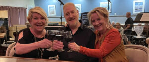 Toasting to a 2023 performance are (l-r) Holly Lane, John Flynn and Lisa Graff.