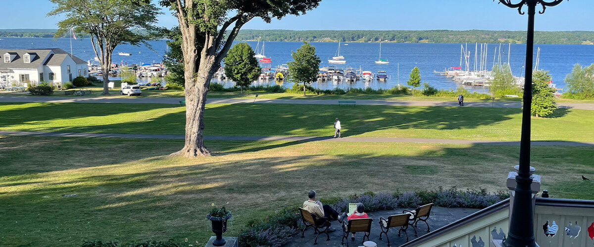Chautauqua Institute guests often sit on the porch and patio outside the Athenaeum Hotel, which offer stunning views of Lake Chautauqua.