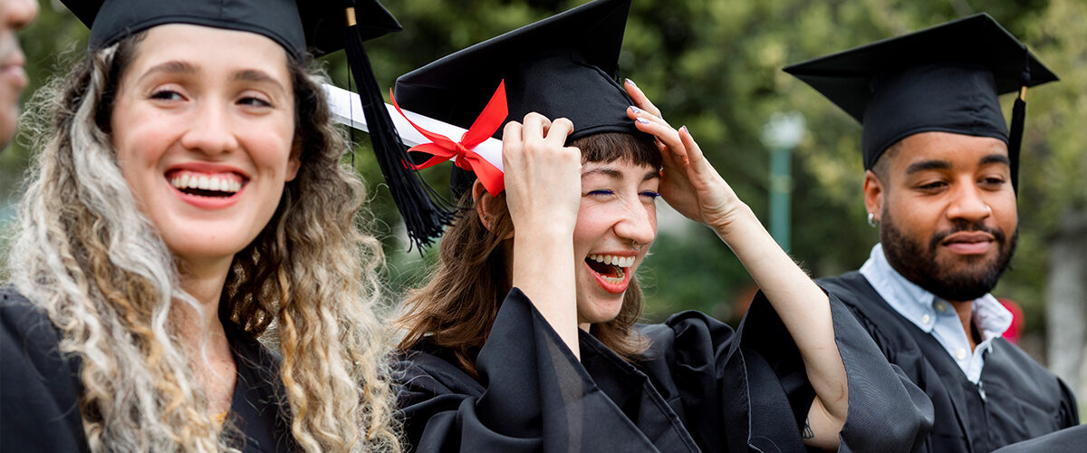 Happy diverse students graduating