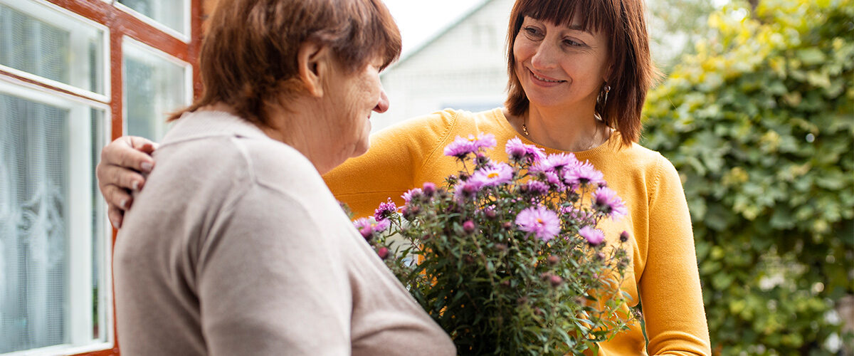 Person helping their elder neighbor